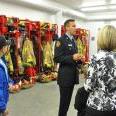 A firefighter provides a tour of Station 1's gear turnout room during the opening.